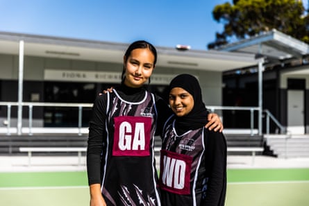 Two girls in newer netball uniforms sanctioned by Netball Australia in December, 2022.