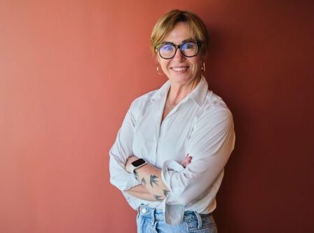 mature businesswoman in highwaisted jeans and button-down