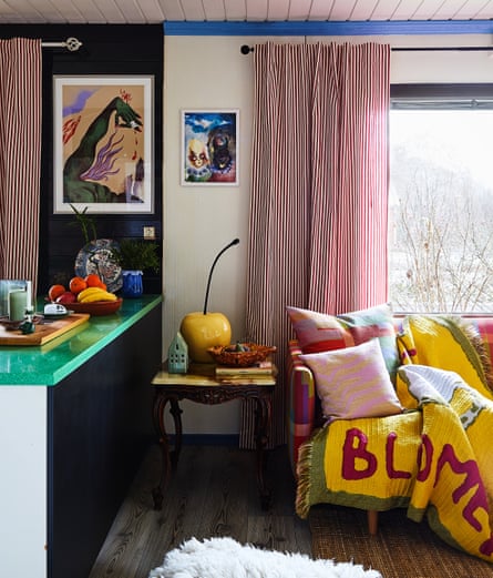 the multi-coloured living room and black kitchen.