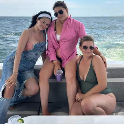 Selena Gomez pairs pink bikini with denim overalls for the perfect summer outfit