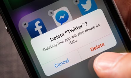 person deleting Twitter from smartphone