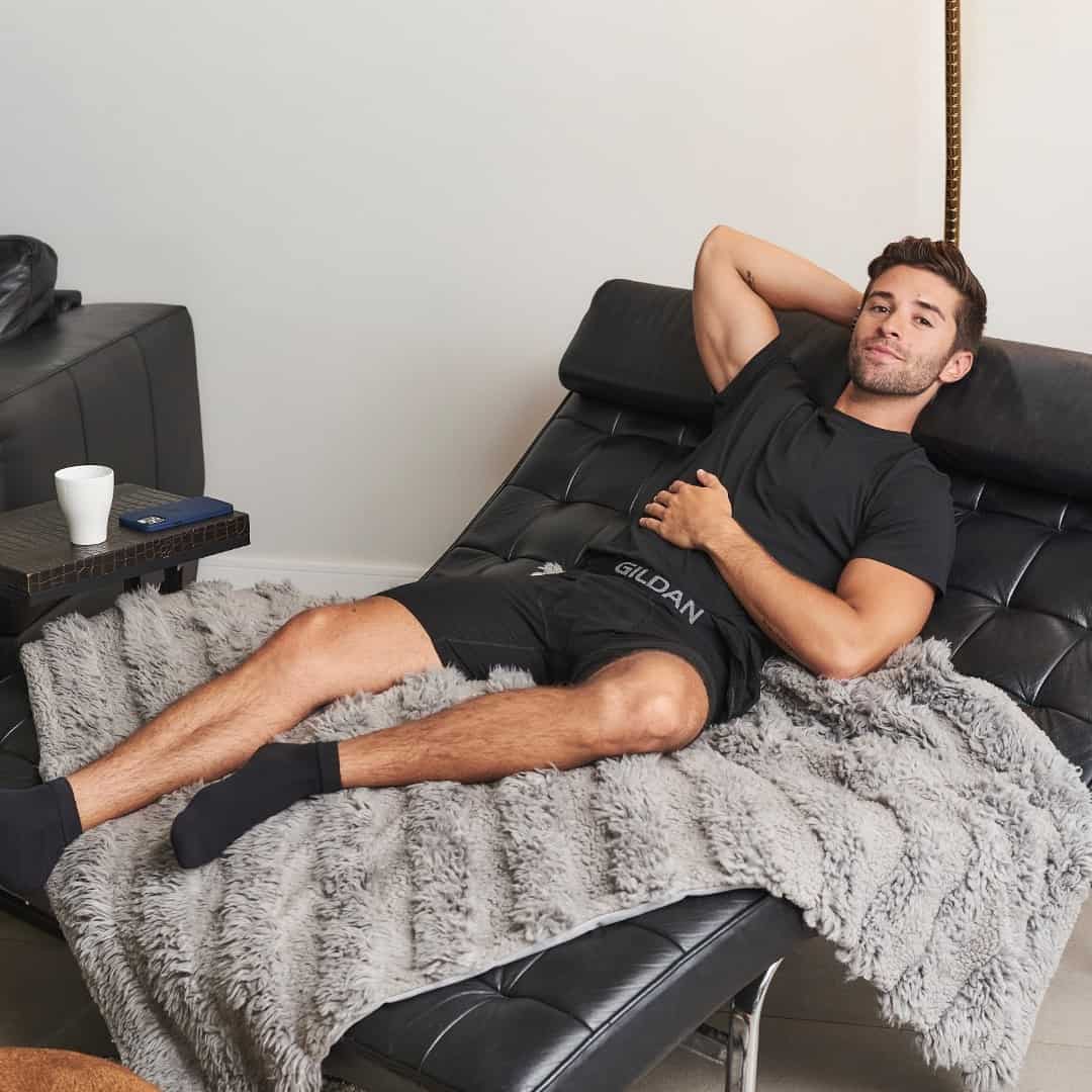 man resting on a sofa bed