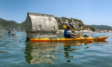 A kayaker paddles past a sunken Lycian tomb at Simena.