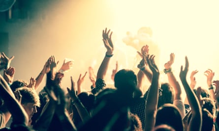 fans with hands aloft at a gig