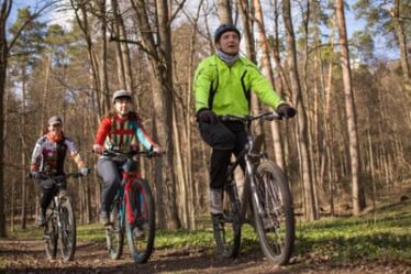 a family group on mountain bikes in woodland