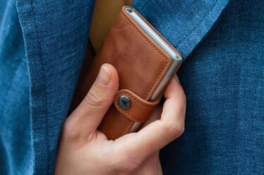 Pulling Out A Secrid Mini Wallet From Jacket