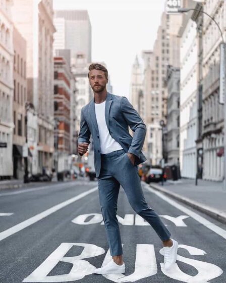 man in a suit crossing the street