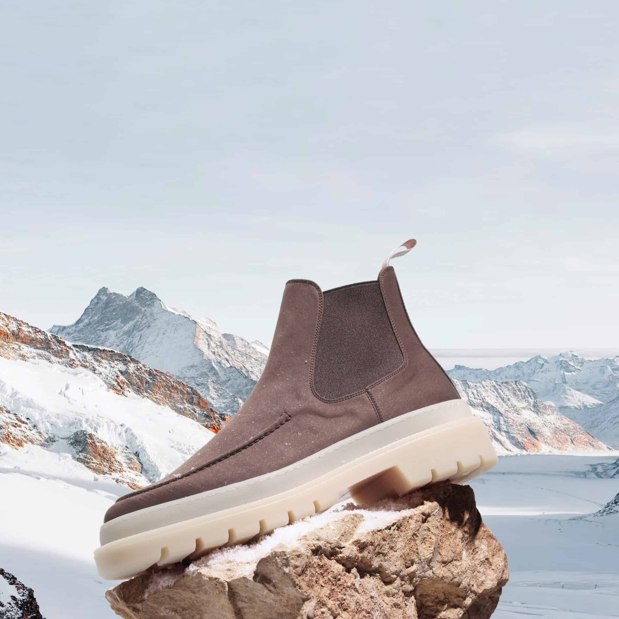 a snow chelsea boot on top of a rock
