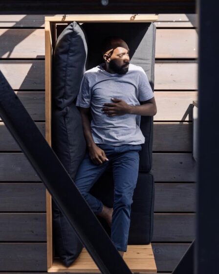 man laying on a couch in t-shirt and jeans