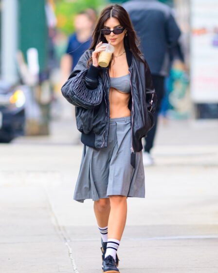 New York NY  Emily Ratajkowski rocks a gray skirt paired with a matching gray top a black leather jacket and a black Miu...