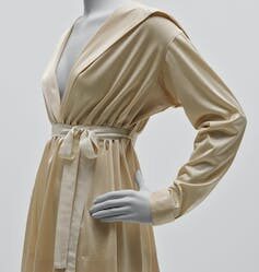 a cream silk blouse with a tie waste.
