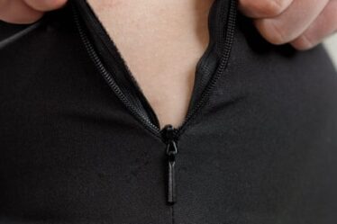 A zipper closing on a tight fitting garment