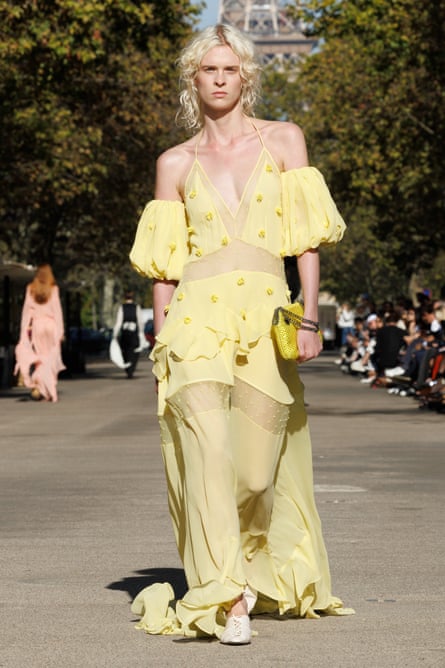 A model wearing a partially sheer yellow maxi dress