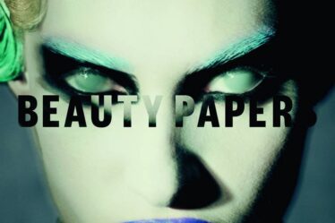 Paolo Roversi's cover for Issue 11 of Beauty Papers features a model with cloudy eyes, green eyebrows, and blue lips.