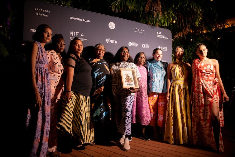 A group of people on a red carpet.