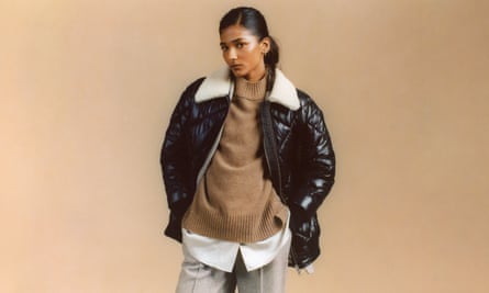 Model in black quiltd jacket with furry collar