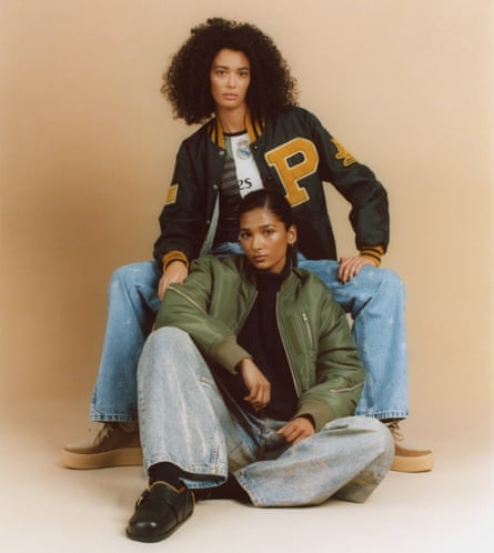 Models wearing green and orange varsity bomber, and olive green bomber