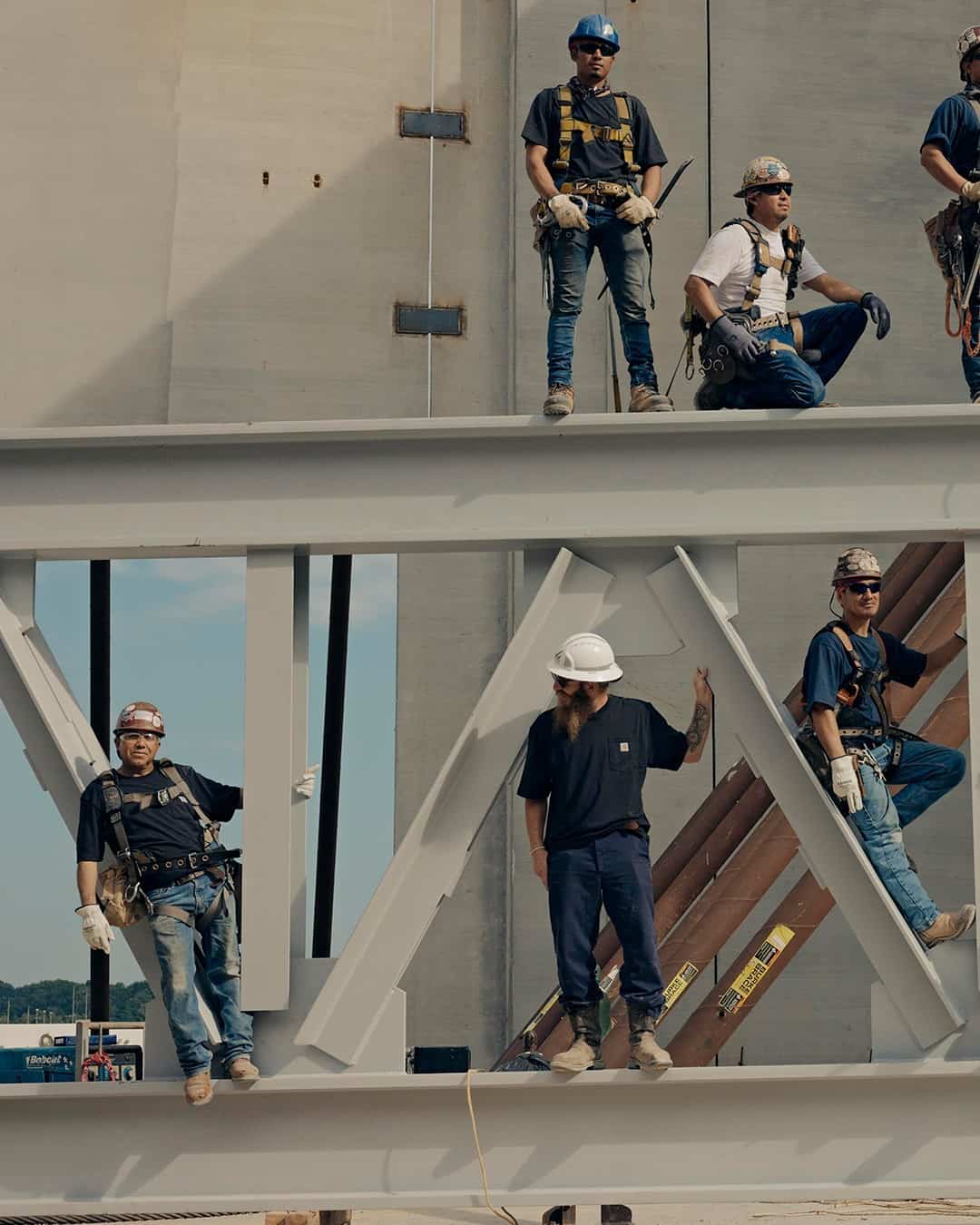 working men on top of a steel beam