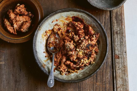 Poached, shredded chicken breasts stirred through the orange-red capsicum spread muhammara and topped with chopped walnuts.