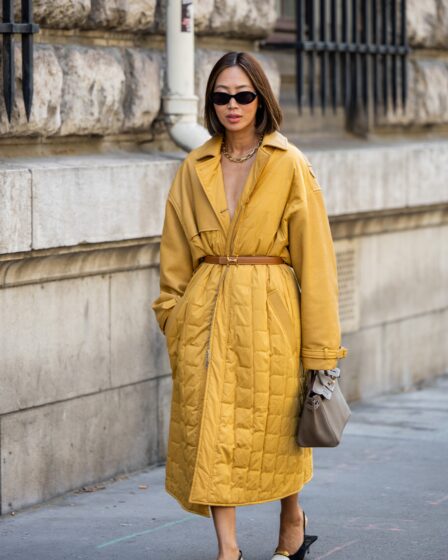 Aimee Song wears belted puffer coat bag heels