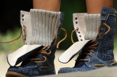 A Child model presents shoes by fashion label Fendi during the “Pitti Immagine Bimbo” fashion fair in Florence.