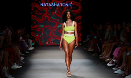 A model wears hemp and cotton blend swimsuit by Natasha Tonic on the runway at Miami Swim fashion week.