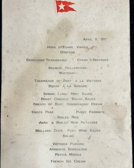 The whole of the waterstained menu revealing all the courses, and showing a red embossed flag with a white star on it at the top