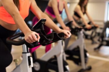 An image of women cycling in a gym environment.