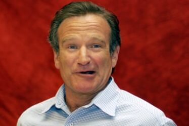 Head and shoulders image of Robin Williams, pictured wearing a shirt at a press conference