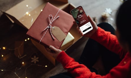 Young woman tracking delivery via smart phone for Christmas shopping online