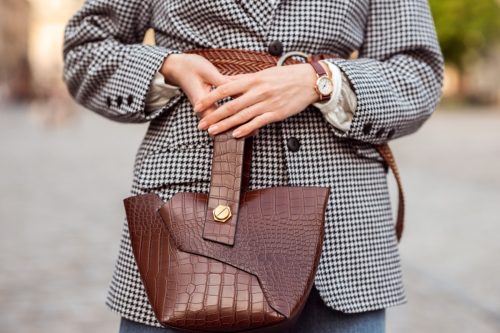 Woman Holding Brown Leather Top Handle Bag