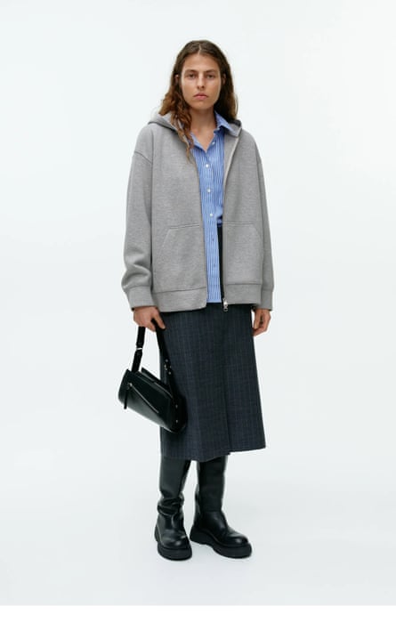 Female model in grey hoodie, blue shirt, black pencil skirt and boots