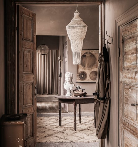 Glittering success: the hallway, with a shell chandelier from Bali and vintage treasures, including the bust of an unknown woman.