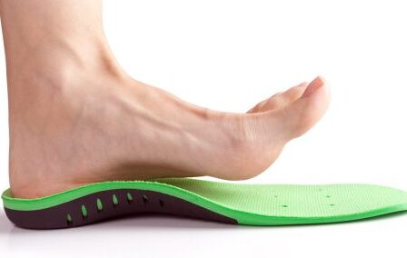 female foot stands on her heel in orthopedic insole