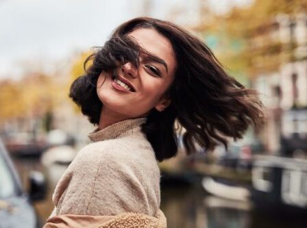 Girl With Short Brown Hair Blowing Outside