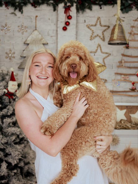 Annabelle holding dog Archie surrounded by Christmas paraphernalia