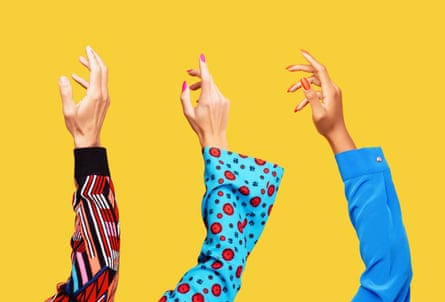 Hands of a white man, a white woman and a black woman reaching up into the air shot on yellow background.