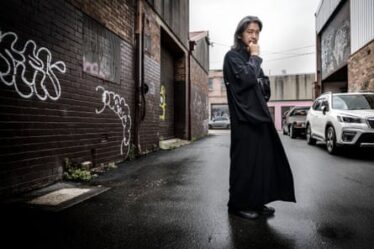 Akira Isogawa in his black, silk kimono outside his studio in Marrickville, Sydney.