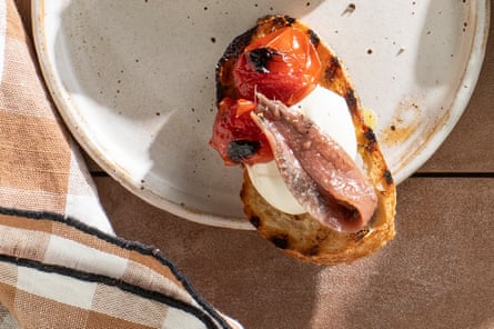 Crostini with ricotta, bursting cherry tomatoes and anchovy