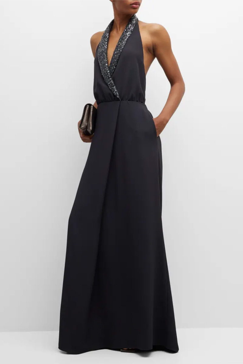 Model wears black gown with tuxedo-style, sequined lapel. 
