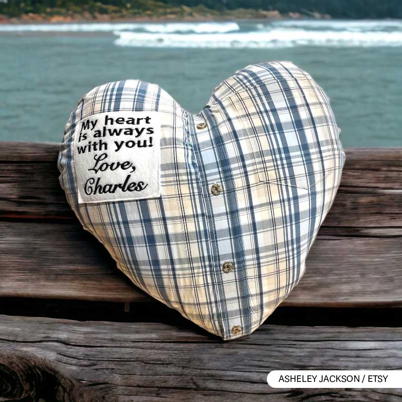 Heart-shaped pillow with patch saying 'My heart is always with you' by the sea.