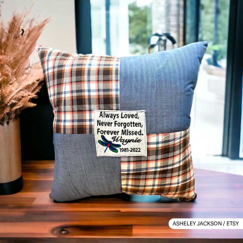 Memorial pillow with plaid pattern and tribute message for Wayne, 1981-2022.