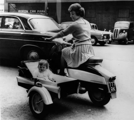 Anita White of Teddington rides a power-driven pram with her daughter, Anita
