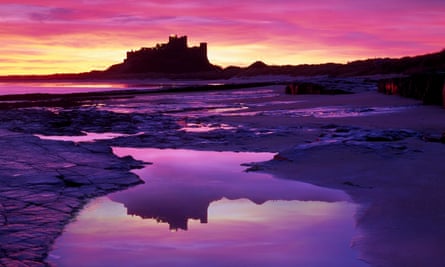 View across the beach at sunset at Bamburgh Castle, Northumberland.