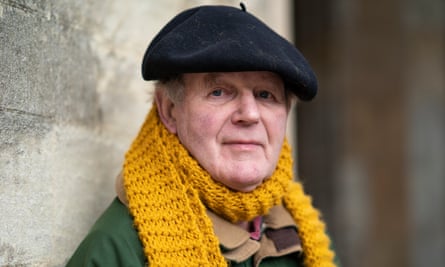 Head shot of writer Michael Morpurgo wearing black beret and orange knitted scarf