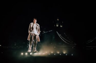 A semi-transparent hologram of Lee Min-ho stands in front of Tower Bridge.