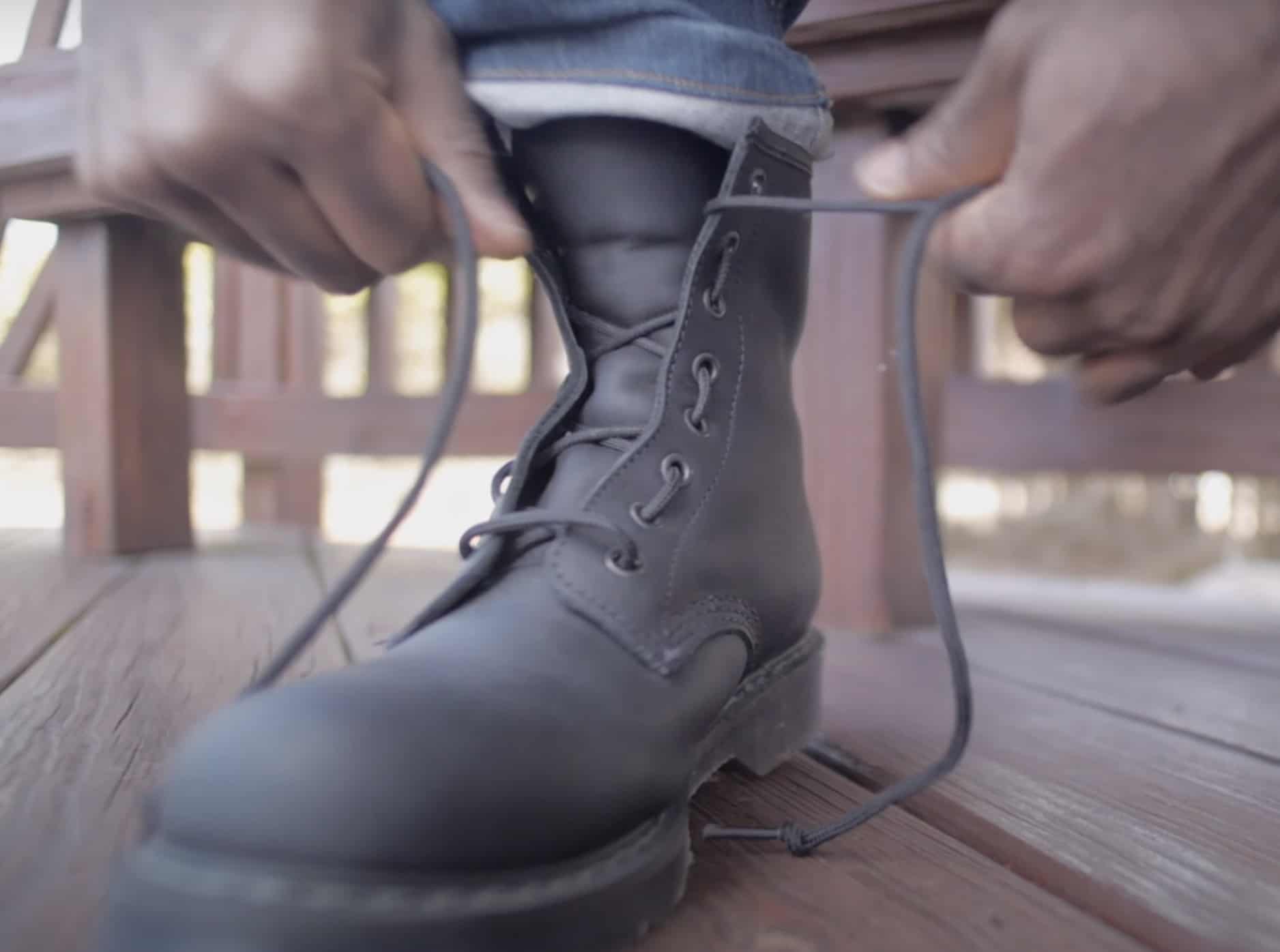 Man lacing up a solovair boot