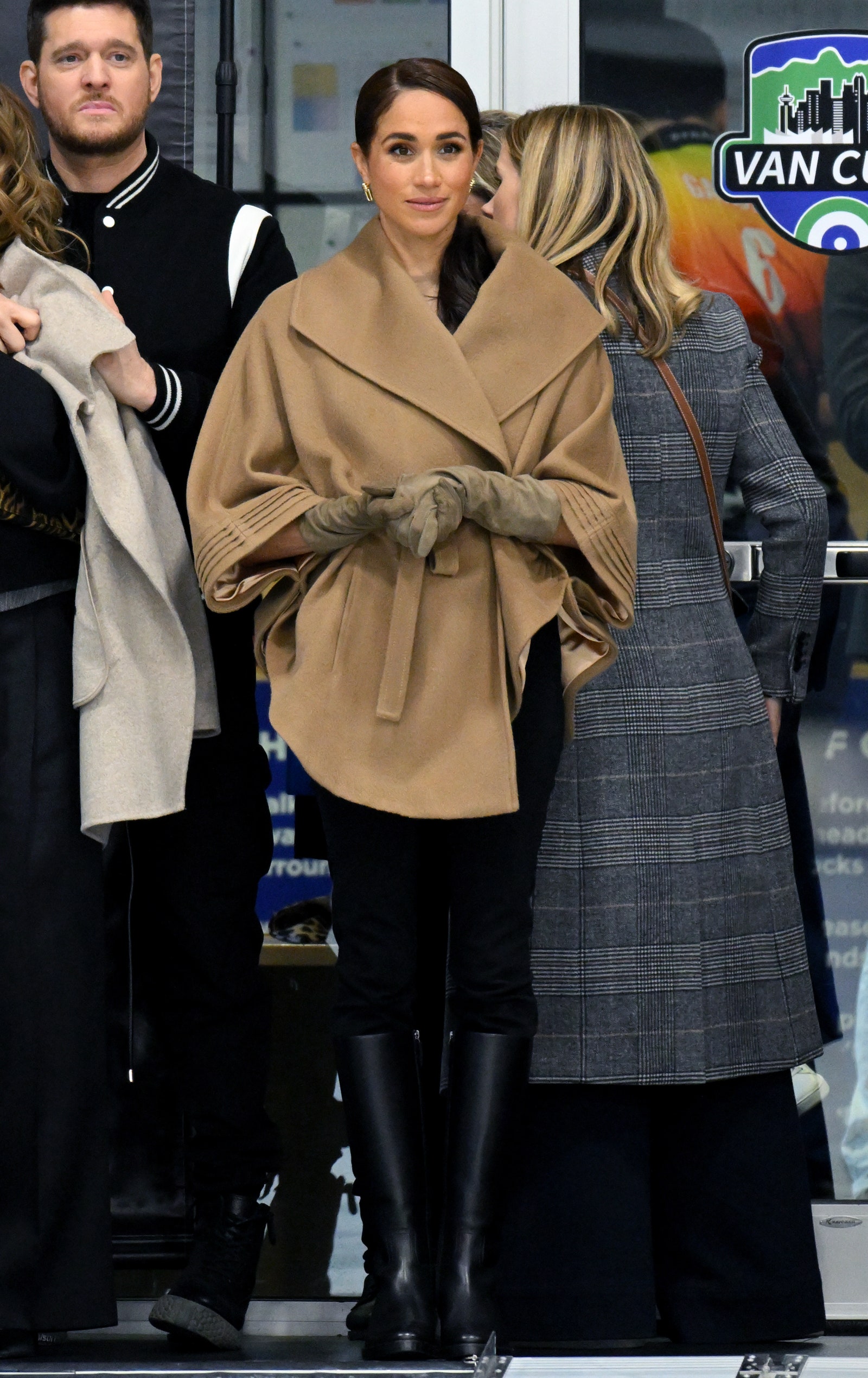 Image may contain Michael Bubl Meghan Duchess of Sussex Clothing Coat Glove Footwear Shoe Adult and Person