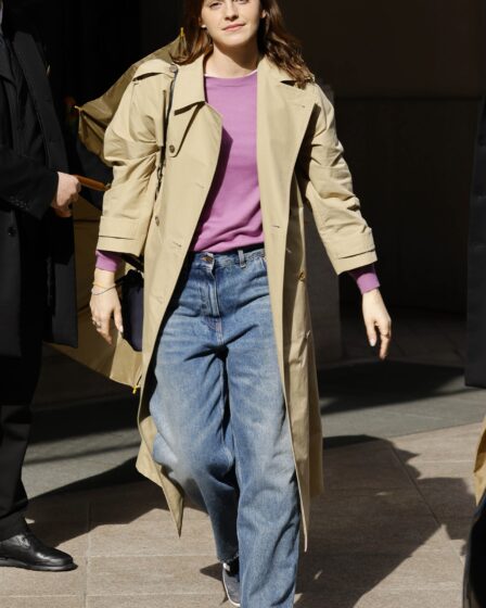 Image may contain Emma Watson Clothing Coat Overcoat Pants Adult Person Footwear Shoe Accessories Glasses and Bag