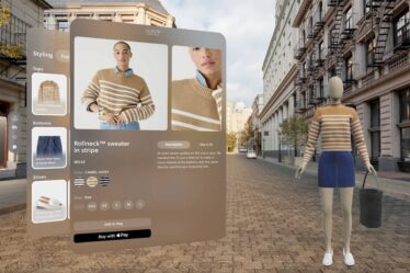 A faceless mannequin poses on a street beside a floating display featuring the striped sweater it's wearing.